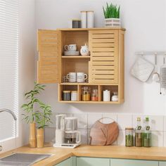 a kitchen with green cabinets and white walls