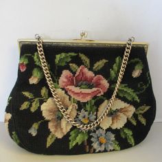 Vintage Floral Needlepoint Purse, This listing is for a vintage, black background with a beautiful floral design needlepoint handbag. This Purse was Designed by CHRISTINE CUSTOM BAGS of Detroit MI.  Known for her needlepoint handbags during the 1940s, her handbags have become highly collectible. These handbags have become so popular due to her use of soft colors, beautiful ornate frames, clasps & chain handles & her jewel tone linings with pleated pockets. Stands 9" Tall, Not Including the Chain Handle, which has a 5" Drop Measures 10.5" Across the Widest Part. The handbag is in very good, Vintage Condition. Vintage Tapestry Bags For Gifts, Handmade Tapestry Bags For Evening, Handmade Tapestry Evening Bags, Victorian Black Rectangular Bag, Formal Embroidered Tapestry Bag, Victorian Style Rectangular Tapestry Bag, Needlepoint Handbags, Needlepoint Purse, Floral Needlepoint