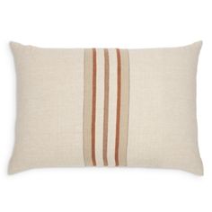 an orange and beige striped pillow on a white background with a brown stripe in the middle