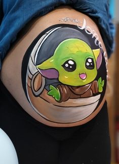 a pregnant belly with an image of a baby yoda on it