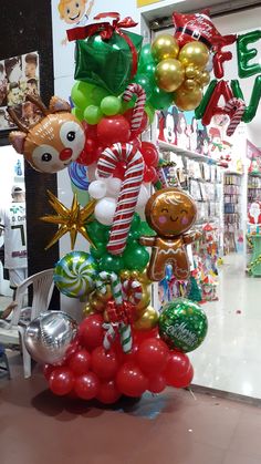 a bunch of balloons in the shape of animals and candy canes are on display