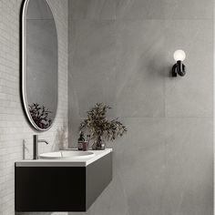 a bathroom with a sink, mirror and toilet paper dispenser on the wall