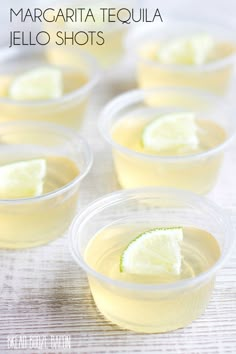 four cups filled with lemonade and lime slices