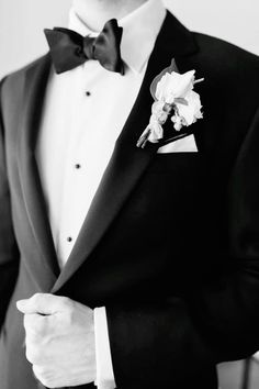 a man in a tuxedo with a boutonniere on his lapel