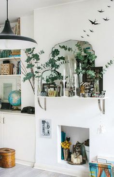 a living room filled with furniture and lots of books on top of a book shelf