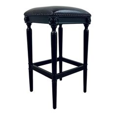 an upholstered black stool with studding on the legs and footrests