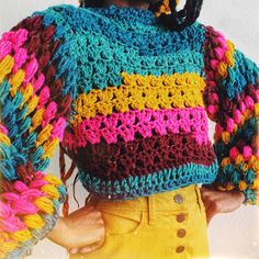 a close up of a person wearing a colorful sweater