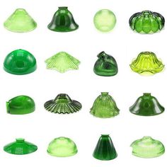 many green glass vases and lids on a white background