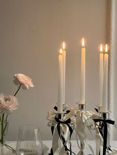 a table topped with candles and vases filled with flowers