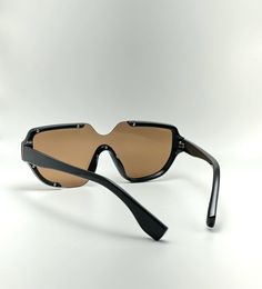 Introducing our newest addition to the sunglasses collection - the UV400 Protection Acetate Frame Semi-Rimless Oval Designer Sunglasses for Men and Women in Black/Gold. Protect your eyes from harmful rays with these non-polarized unisex sunglasses, featuring a lens width of 74 millimeters, a bridge of 18 millimeters and a lens length of 149 millimeters.Enjoy maximum comfort with these lightweight sunglasses that stay in place for longer periods. The black frame coated with gold makes for an eye-catching combination that is sure to uplift your mood. Not only will you look great, but you will also enjoy the high-quality material used to construct these glasses - acetate frames, stainless hinges and fine-grade polarized lenses.We take pride in offering quality products at reasonable prices an Rimless Tinted Shield Sunglasses, Rimless Shield Sunglasses With Tinted Lenses, Rimless Plastic Shield Sunglasses With Tinted Lenses, Trendy Rimless Outdoor Sunglasses, Trendy Outdoor Rimless Sunglasses, Rimless Plastic Shield Sunglasses With Gradient Lenses, Modern Shield Sunglasses For Beach, Rimless Tinted Shield Sunglasses For Beach, Rimless Shield Sunglasses For Beach With Uv Protection