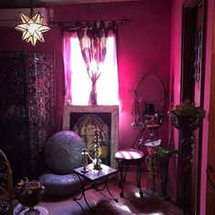 a living room filled with furniture and pink walls