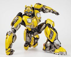 a yellow and black robot standing next to each other