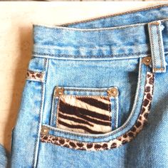 a pair of jeans with animal print pockets