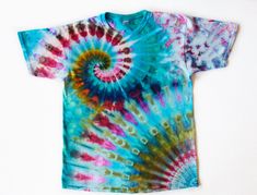 a tie - dyed t - shirt is shown on a white background