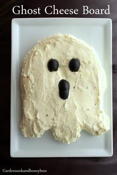 a white plate topped with a cake shaped like a ghost