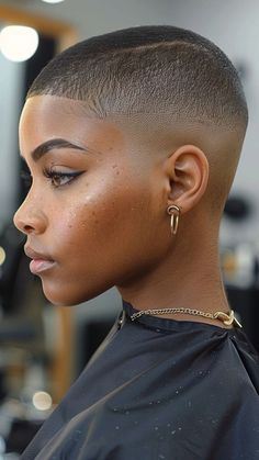 Embrace a bold, minimalist look with a Buzz Cut from our 30 Short 4C Hairstyles guide! This low-maintenance style highlights your natural texture with effortless cool. Click the pin and follow us for more chic and easy hair ideas! #BuzzCut #4CHairstyles #NaturalHair #EffortlessChic #BoldStyles Fade On Women, Low Fade Women, Stud Haircut Black, Fade Black Woman, Afro Pixie Haircut, Black Woman Buzzcut, Rose Gold Hair Black Women, Black Women Buzzcut, Black Women Shaved Head