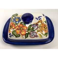 a blue and white dish with flowers painted on it