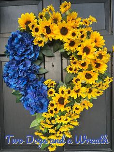 a wreath with sunflowers and blue hydrangeas hanging on a front door