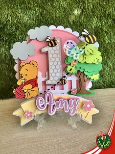 a winnie the pooh 1st birthday cake topper