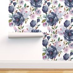 the wall paper has blue and pink flowers on it