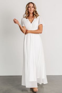 Baltic Born exclusive style! Simple off white color High-quality chiffon material that flows beautifully V-neckline Short flutter sleeves Smocked waist for a comfortable fit Pull-over style Fully lined excluding sleeves Bump friendly 100% Polyester Trina is 5'6, cup size 32D, size 2 and is wearing size S White V-neck Maxi Dress With Smocked Back, White Casual Maxi Dress With 3/4 Sleeves, Feminine Off-white Short Sleeve Maxi Dress, White V-neck Maxi Dress With Button Closure, White V-neck Maternity Maxi Dress, Maxi Dress White, Baltic Born, Maxi Gown, Chiffon Material