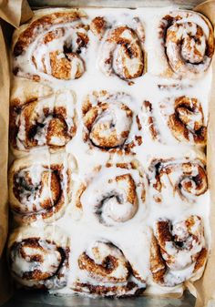 cinnamon rolls in a pan with icing on top