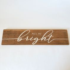 a wooden sign that says, all is bright