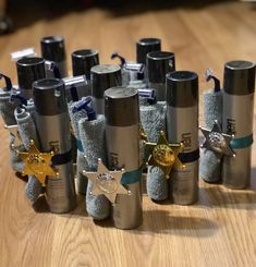 several rolled up bottles with star decorations on them sitting on a wooden table next to each other