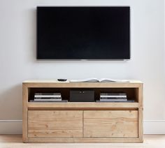 a flat screen tv mounted to the side of a wooden cabinet