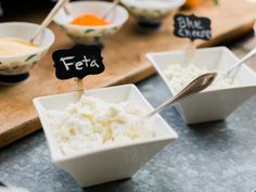 small bowls filled with food sitting on top of a table