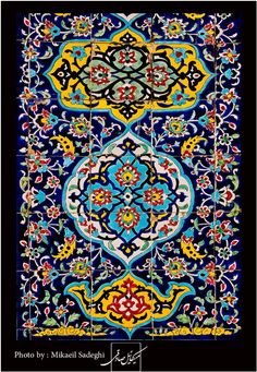 an intricately designed tile in blue, yellow and green colors with floral designs on it