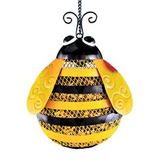 a yellow and black glass ornament hanging from a chain