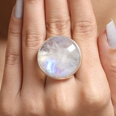 "Rainbow Moonstone Ring / 925 Sterling Silver Ring / Round Shape Ring / June Birthstone Ring / Handmade Ring / Boho Jewelry / Gift For Her Gemstone Name - Rainbow Moonstone Stone Quality - AAA Ring Wight - 14.70 gm  Ring Length - 2.8 cm   Ring Width - 2.8 cm  Stone Shape - As shown in the picture Ring Size - All Ring Size Available You'll get the exact product as shown in the pictures We serve complete 925 sterling silver Jewelry and genuine properties of the stone. The products are dispatched from the small business from USA. Product Quality and Packaging - Our all products are 925 Silver Stamped which shows that the product is genuine and authentic .The products are dispatched from the small business from USA so you get the product on time and the product packaging comes in bubble foil w Sterling Silver Round Moonstone Ring With Moon Phase, Minimalist Round Jewelry With Large Stone, Large Moonstone Spiritual Ring, Sterling Silver Celestial Crystal Ring, Celestial Crystal Ring In Sterling Silver, Celestial Sterling Silver Crystal Ring, Round Crystal Healing Ring With Gemstone, Moonstone Jewelry With Large Round Stone, Sterling Silver Moonstone Ring With Natural Stones