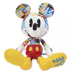 a mickey mouse stuffed animal sitting on top of a white surface