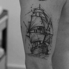 a black and white photo of a ship tattoo