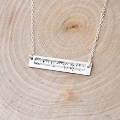 "This is a personalized sheet music bar necklace. Use any song you would like. We use the first stanza from the chosen song. Makes a wonderful Valentine's Day gift. Details Metal: Solid Sterling Silver (.925 silver), Gold, Rose Gold Thickness: 20 gauge ShownWidth: 1.25\" ShownHeight: .20\" Chain Length: 16, 18, or 20 inches Options Include Song Title: You can choose to have the song title engraved on the necklace as well Backside Engraved: You can choose to have the back side engraved. Popular o Personalized Music-themed Necklaces For Anniversary, Music-themed Personalized Necklaces For Anniversary, Music Necklace, Music Bar, Wedding Song, Gift For Girlfriend, Bar Necklace, Necklace Gift, Gold Rose