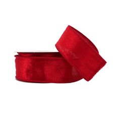 a roll of red velvet ribbon on a white background