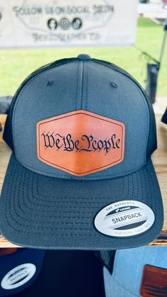 We The People Leather Patch Hat, Custom Leather Patch Hats Ready to rock this "We The People" leather patch hat!! We bet you are!! :) Get yourself a handmade leather patch hat that will leave a lasting impression!  This is superb gift for Husbands, Dads, Grandads and any Texas Lovers out there. Cleaning: Hats should be gently spot cleaned with damp rag only. HOW TO ORDER: 1. Select Quantity  2. Select Hat Color  Your order is individually handmade by me or my wife Karina. Little helper Isabella Trucker Style Leather Snapback Hat With Leather Patch, Black Leather Snapback Hat With Curved Bill, Leather Snapback Cap With Leather Patch, Leather Trucker Hat With Curved Bill And Patch, Leather Snapback Trucker Hat With Leather Patch, Custom Black Hat With Leather Patch, Black Leather Trucker Hat With Leather Patch, Hat With Leather Patch, Leather Patch Hat