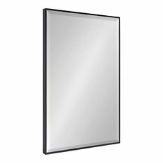 a black framed mirror on a white wall