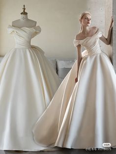 a woman standing next to a mannequin wearing a white dress with an off the shoulder neckline