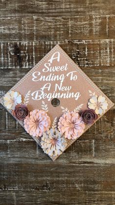 a graduation cap with flowers on it and the words, sweet ending to all new beginning