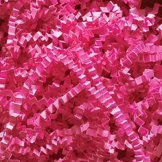 a large pile of pink colored confetti