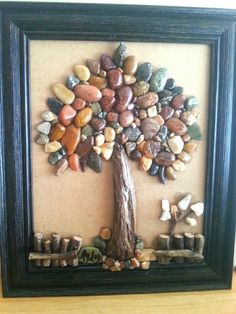 a tree made out of rocks in a frame