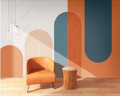 an orange chair sitting next to a wooden table in front of a wall with circles on it