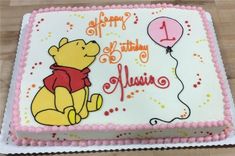 a winnie the pooh birthday cake on a table