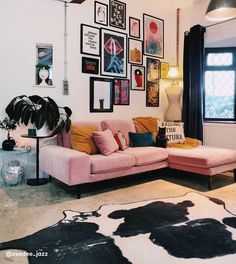 a living room filled with lots of furniture and pictures on the wall above it's couch