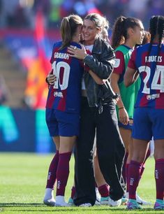 the women's soccer team is hugging each other