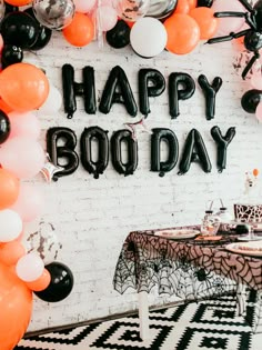 an image of a happy boo day party with balloons on the wall and spider decorations