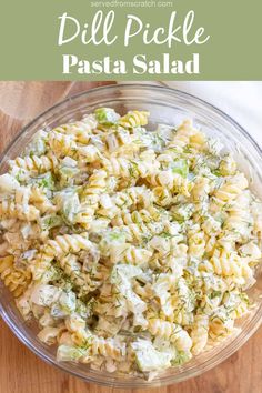 a bowl filled with pasta salad on top of a wooden table