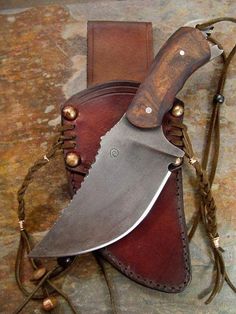 a knife is sitting on top of a leather sheath